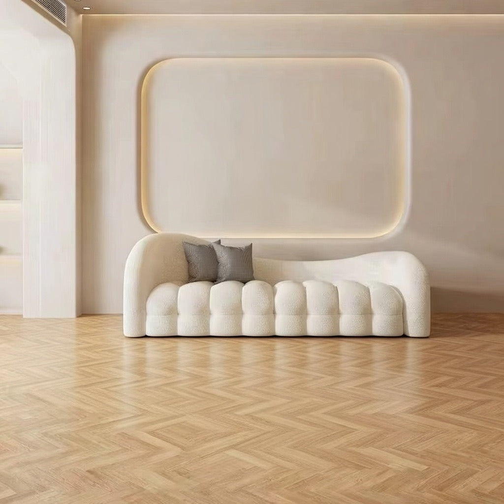 Modern white sofa with two gray cushions against a beige wall. Boucle salon furniture 
