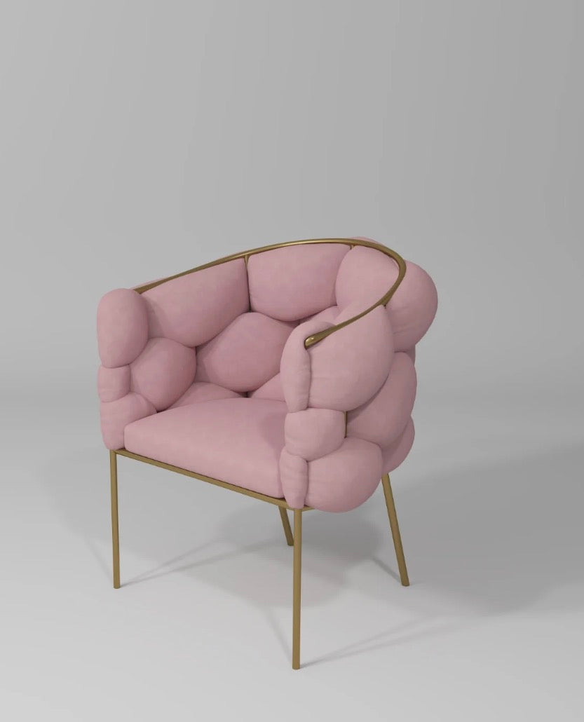 Pink cushioned chair with gold frame on a white background