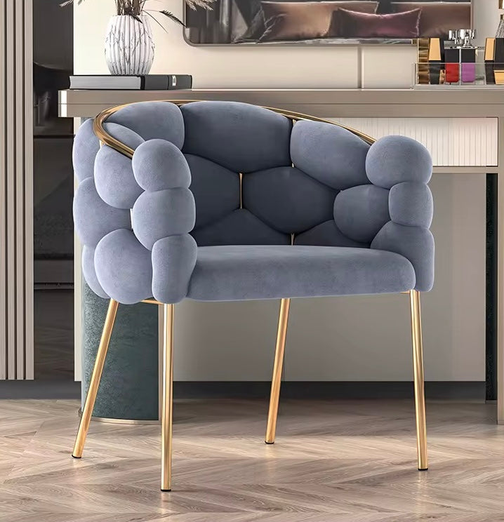 Modern blue chair with gold legs in a room setting