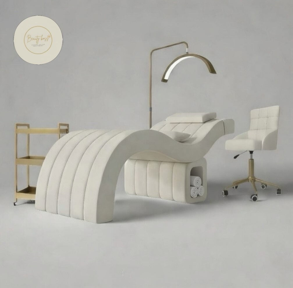 Modern white treatment bed with lamp and chair in a neutral setting beauty bed lash bed 