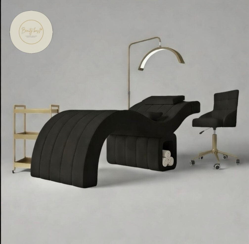 Modern black massage table with a lamp and chair on a gray background beauty bed 