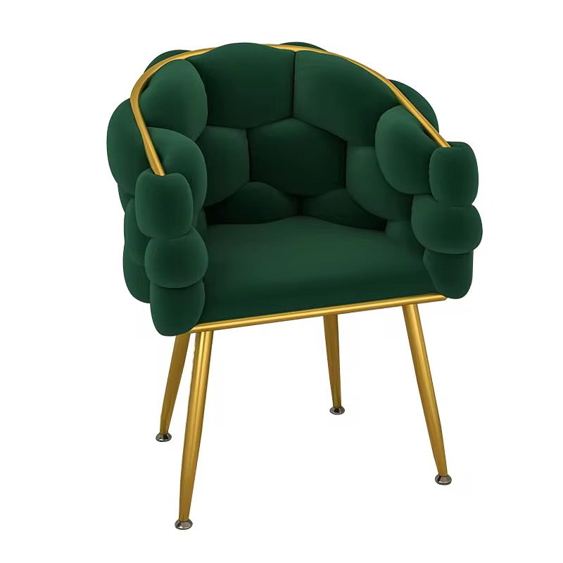 Green armchair with gold accents on a white background