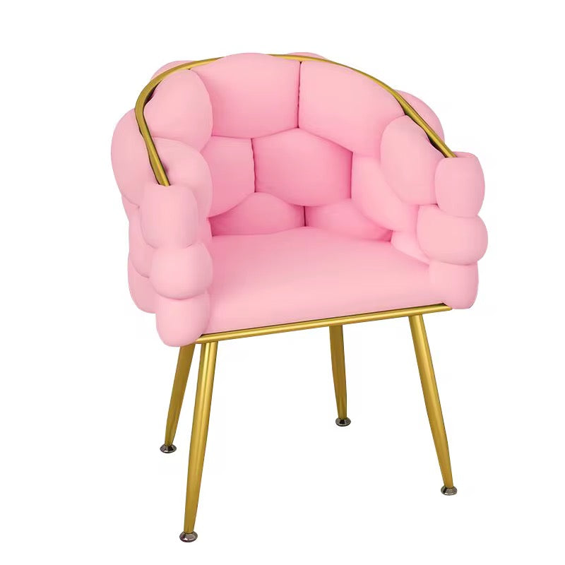 Pink cushioned chair with gold frame on a white background