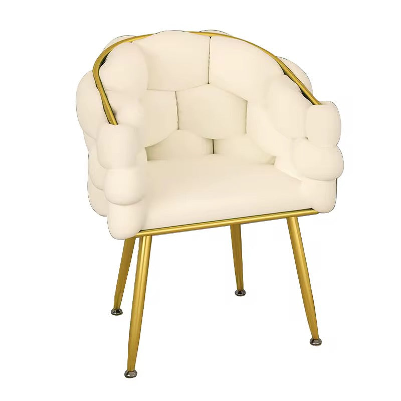 Cream-colored armchair with gold frame on a white background
