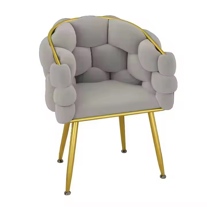 Chair with gray cushioned backrest and gold frame on a white background